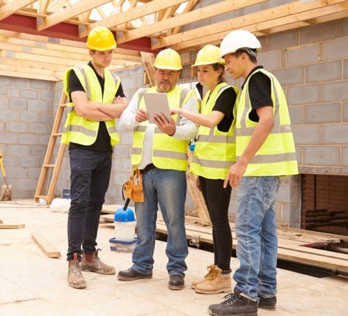 Manager reviewing safety steps with young workers.