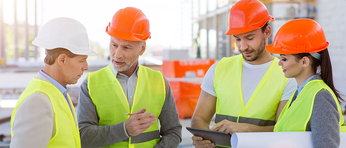 Construction crew discussing their action plan for workplace safety.