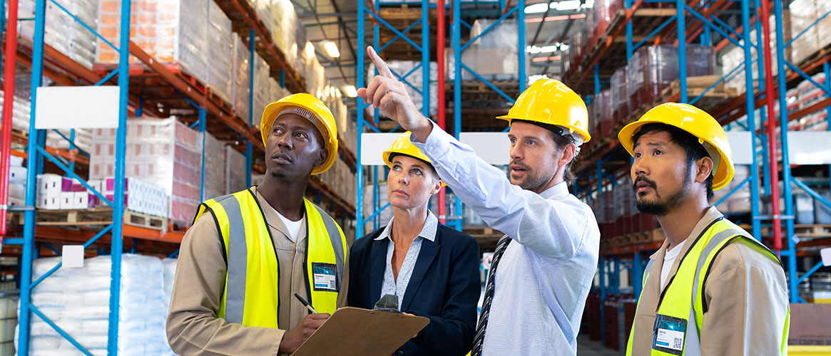 Warehouse workers inspecting the racks and shelves at their workplace.