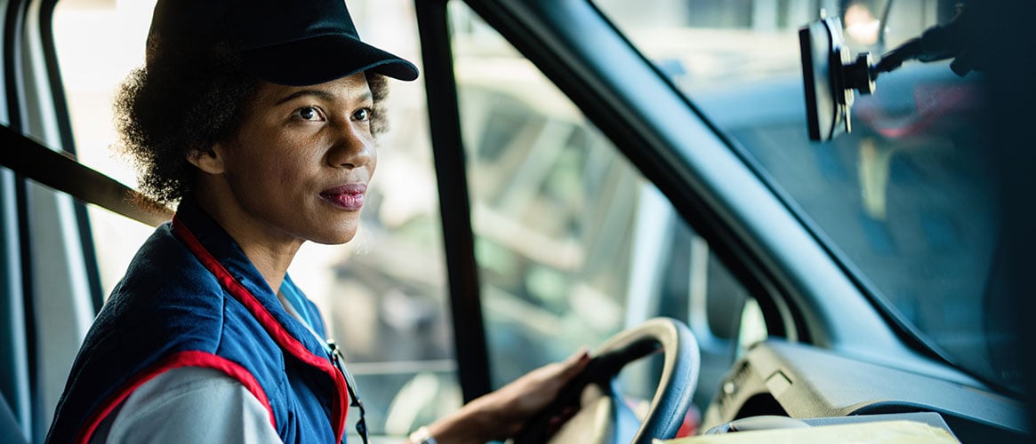 Delivery driver heading off to the next stop, wearing a seatbelt.