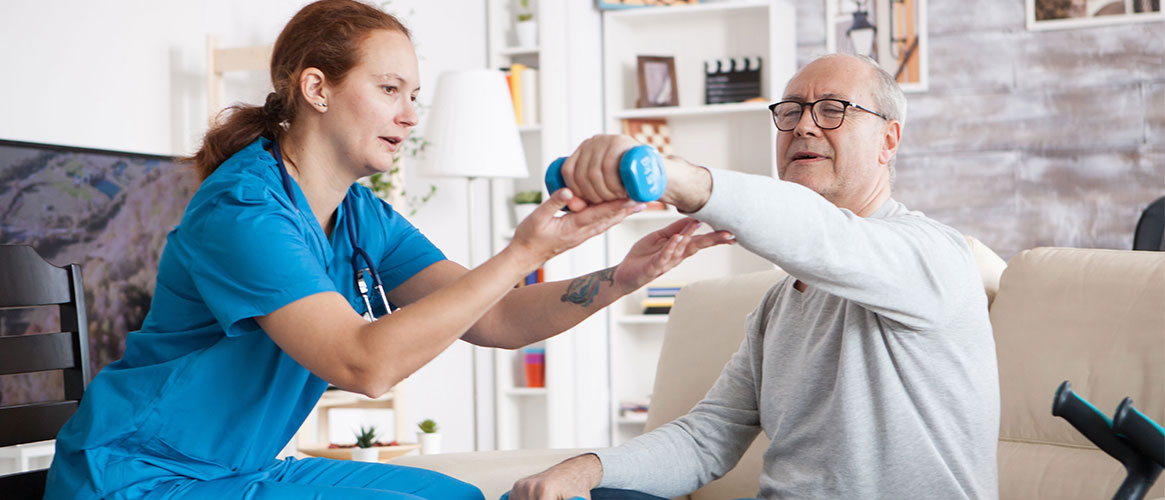 Home health aide assisting patient with light weightlifting
