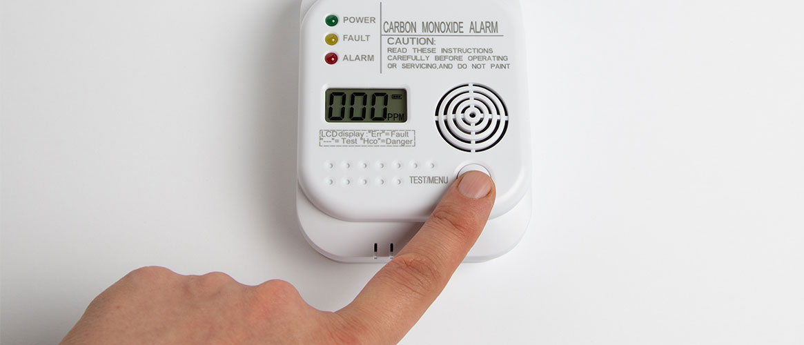 Worker testing a carbon monoxide detector