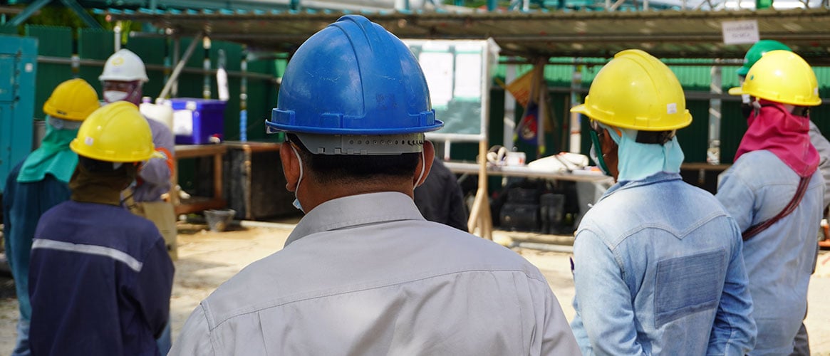 Employees standing down from work to discuss safety at their construction site