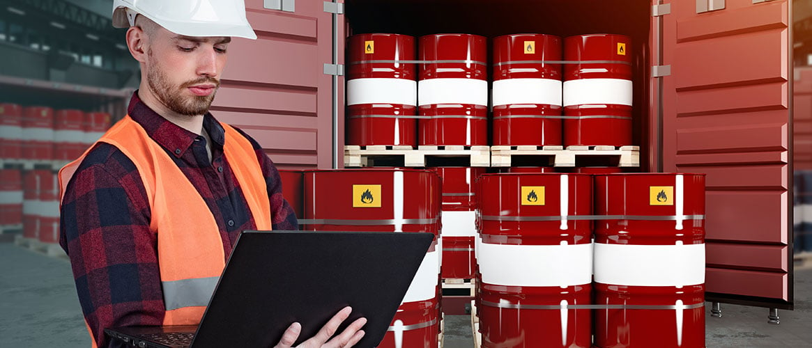 Employee checking hazard information on substances stored in a warehouse