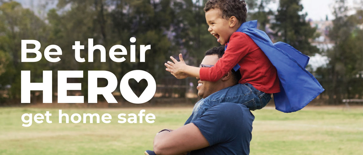 Be their hero. Get home safe. Healthy dad carrying son in hero cape on shoulders