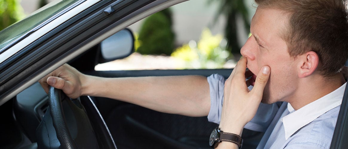 Drowsy driver yawning from not getting enough sleep