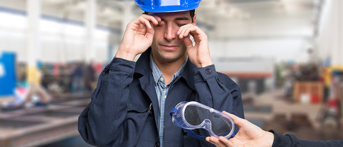 worker rubbing eyes