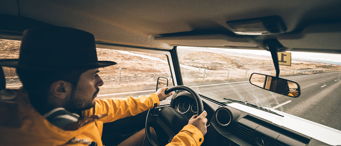 Commercial truck driver driving safely down highway with no distractions or signs of fatigue